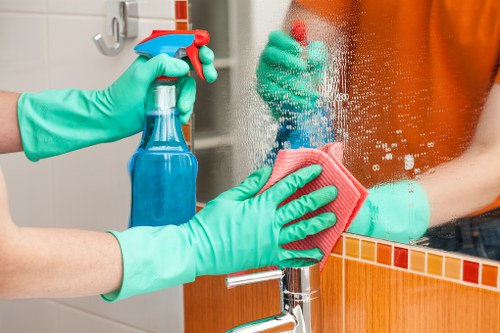 Cleaner loading household waste from a Richmond apartment clear-out